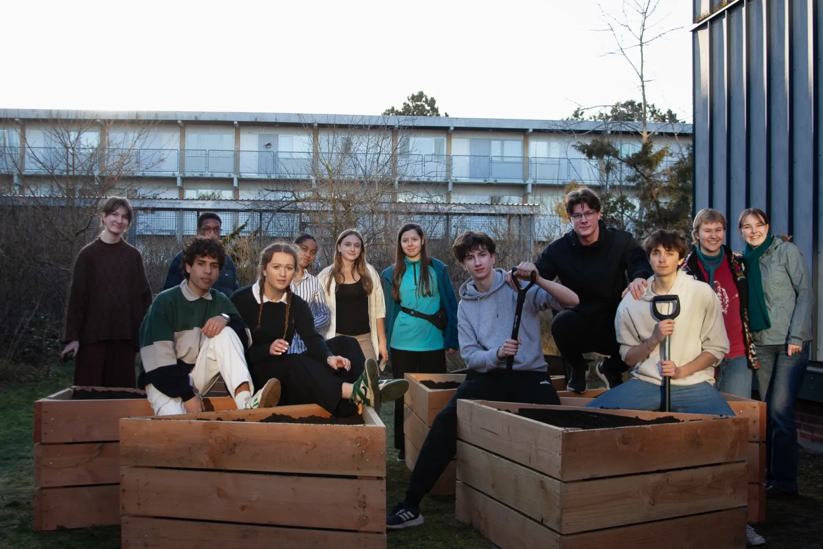 Students with the raised garden beds they built for a climate project