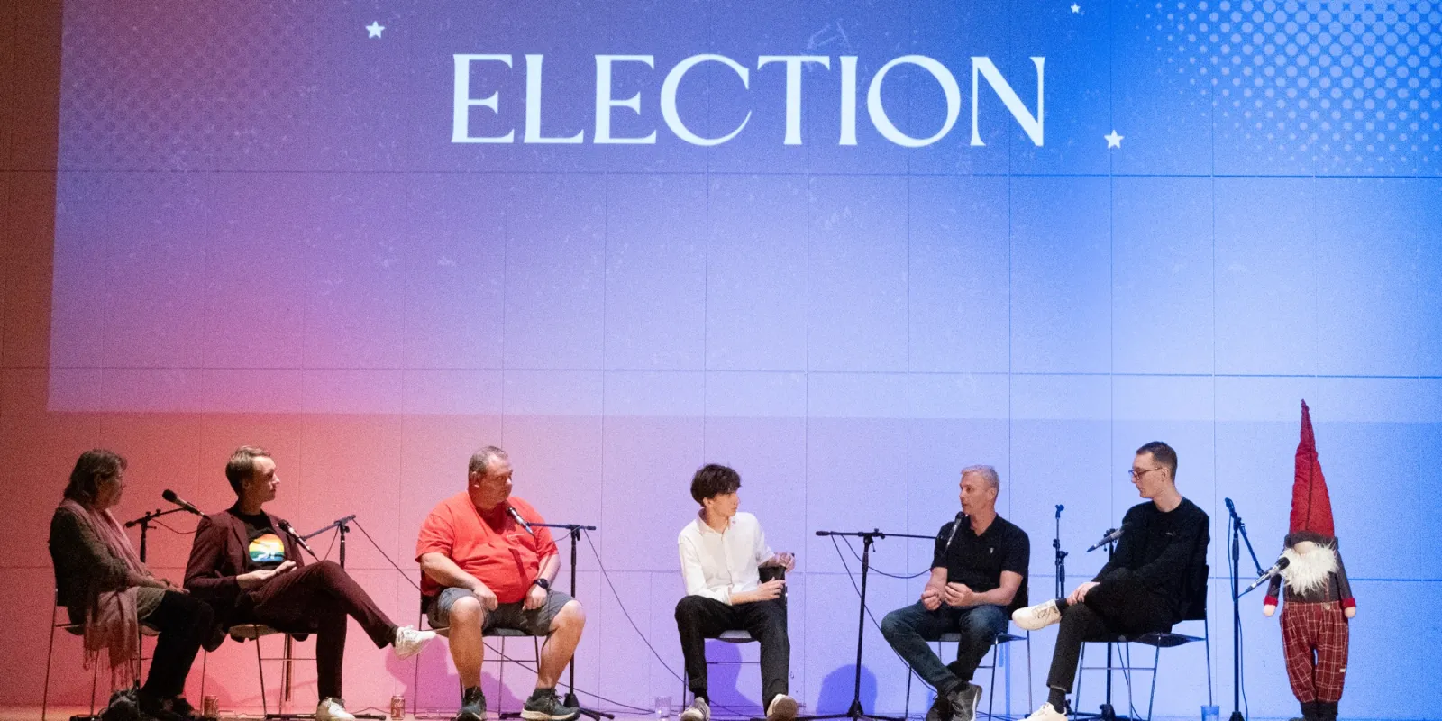 A panel on stage at a political debate